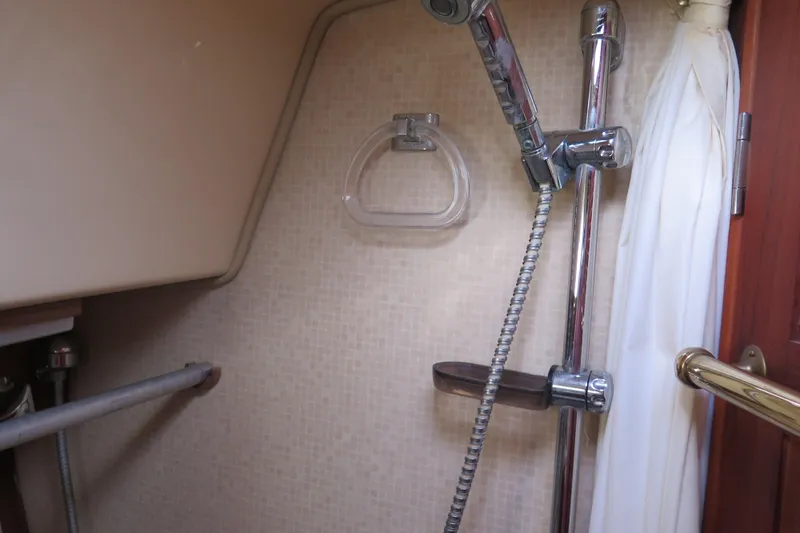 Slide: The Image of 1990 Island Packet 35 yacht kitchen with wooden cabinetry and built-in appliances. - 45