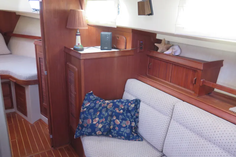 Slide: The Image of 1990 Island Packet 35 yacht kitchen with dual sink and stove, featuring wooden cabinetry. - 46