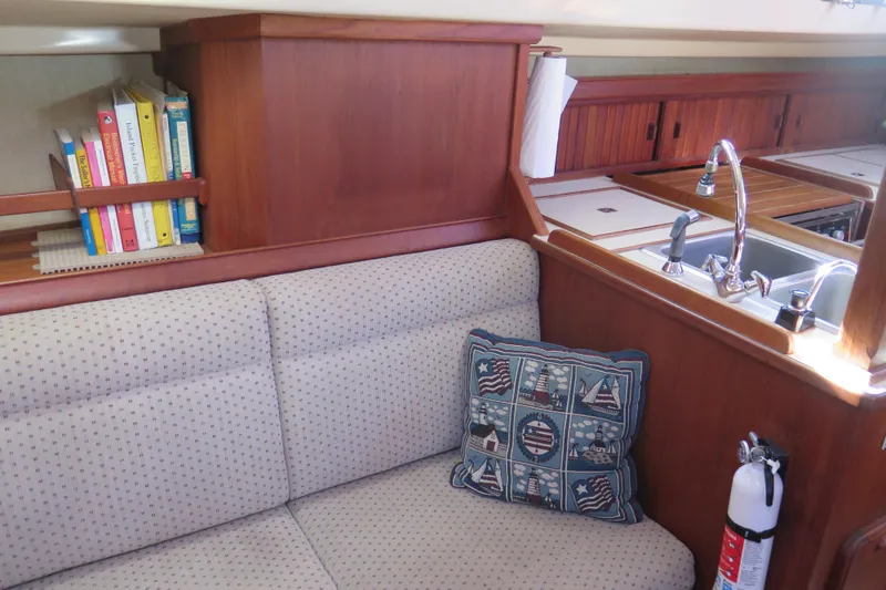 Slide: The Image of Interior of 1990 Island Packet 35 sailboat with cozy seating and kitchen sink. - 47