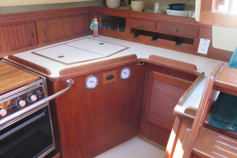 Slide: The Image of Cozy cabin interior of 1990 Island Packet 35 sailboat with plush bedding and teddy bear. - 48