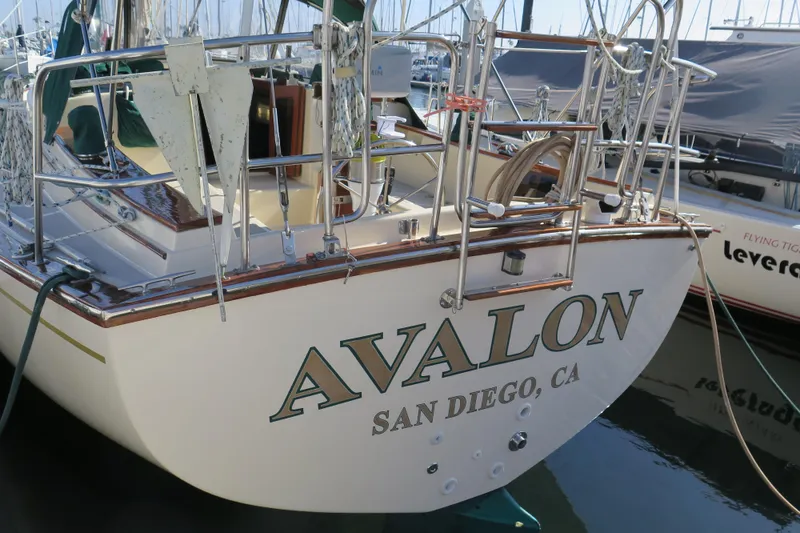 Slide: The Image of 1990 Island Packet 35 sailboat docked in a marina, showcasing its sleek design and craftsmanship. - 5