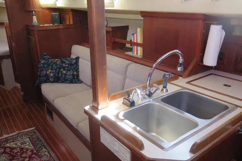 Slide: The Image of 1990 Island Packet 35 interior with wooden cabinetry and fire extinguisher. - 50