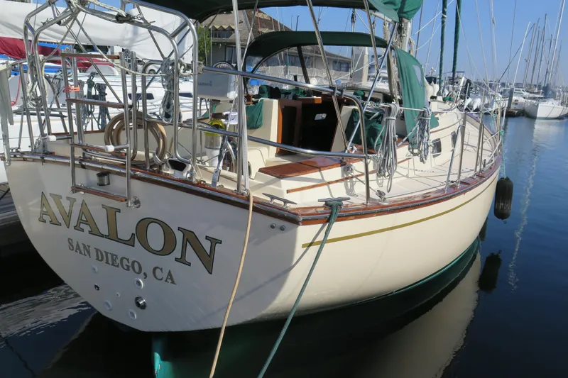 Slide: The Image of 1990 Island Packet 35 sailboat docked in a marina under clear blue skies. - 9