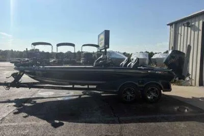 Slide: The Image of 2025 Ranger Z520R boat parked outdoors near a building under clear skies. - 5