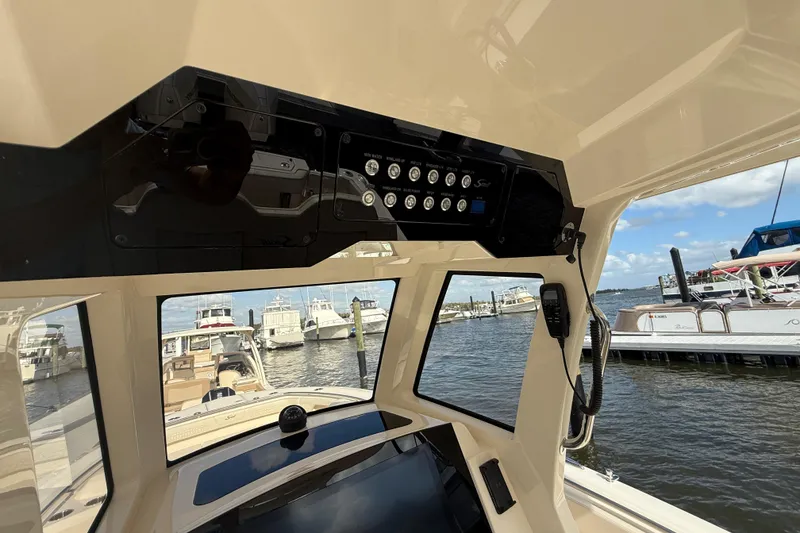 Slide: The Image of Interior view of 2026 Scout 288 LXF boat dashboard at marina. - 10