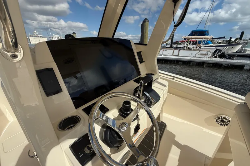 Slide: The Image of 2026 Scout 288 LXF boat helm with modern controls and navigation display. - 12