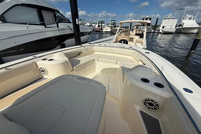 Slide: The Image of 2026 Scout 288 LXF boat interior at marina, featuring spacious seating and modern design. - 17