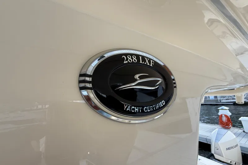 Slide: The Image of 2026 Scout 288 LXF yacht certified emblem on boat exterior. - 22