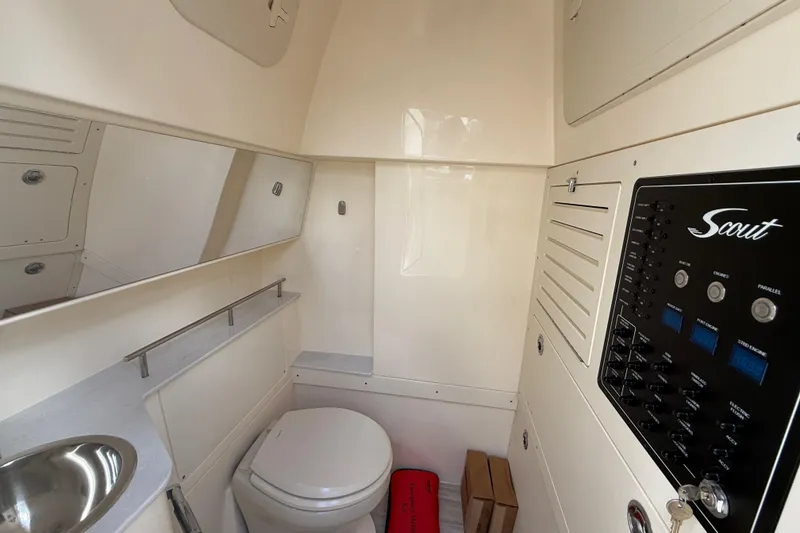 Slide: The Image of 2026 Scout 288 LXF boat interior with toilet, sink, and control panel. - 28