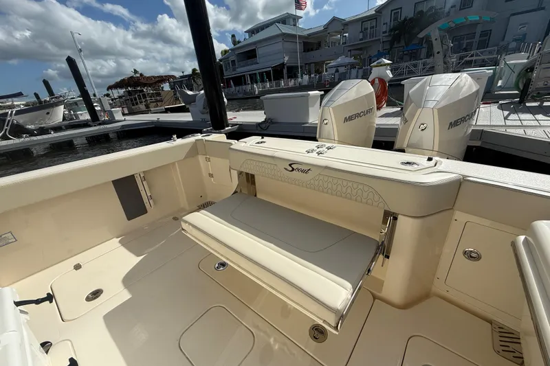 Slide: The Image of 2026 Scout 288 LXF boat interior with Mercury engines at a marina. - 4