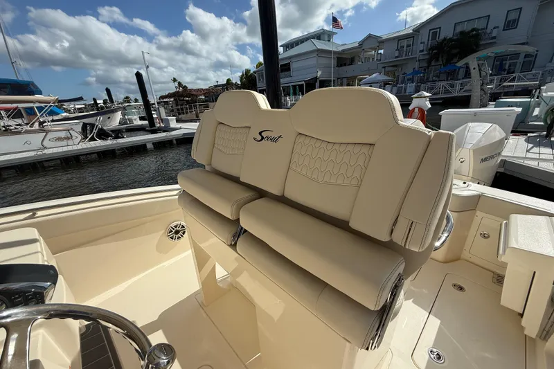 Slide: The Image of 2026 Scout 288 LXF boat interior with luxurious seating at marina. - 7