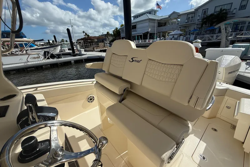 Slide: The Image of 2026 Scout 288 LXF boat interior with luxurious seating at marina. - 8