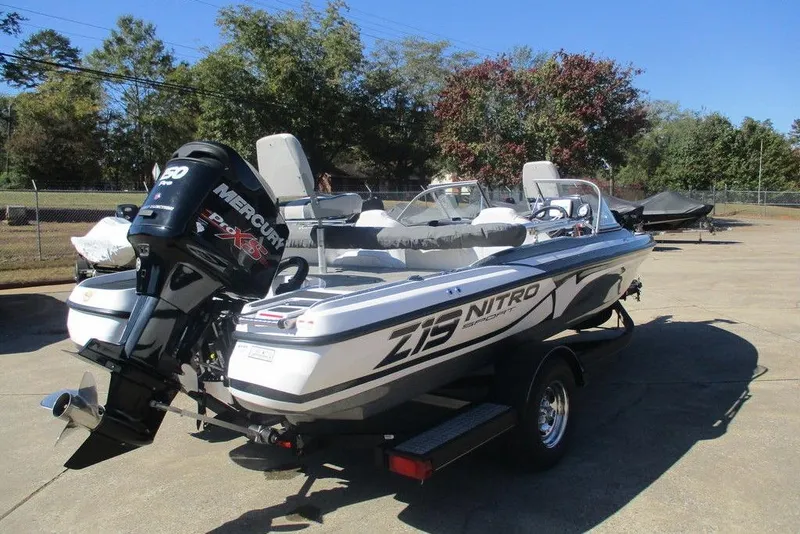 Slide: The Image of 2026 Nitro Z19 Sport boat with Mercury engine on trailer, parked outdoors. - 3