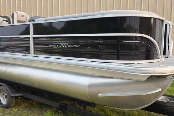 The Image of 2026 Sun Tracker Party Barge 20 DLX pontoon boat on trailer, side view. - 1