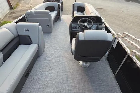 Slide: The Image of 2026 Sun Tracker Party Barge 20 DLX interior with spacious seating and modern helm. - 3