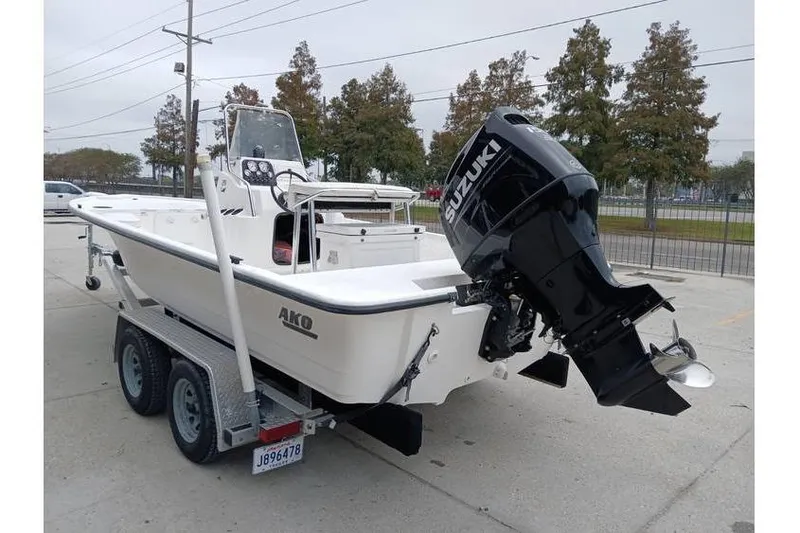 Slide: The Image of 2006 Mako 211 Inshore boat on trailer with Suzuki outboard motor. - 2