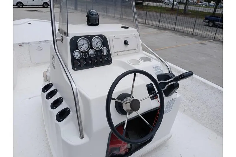 Slide: The Image of 2006 Mako 211 Inshore boat console with steering wheel and gauges. - 8