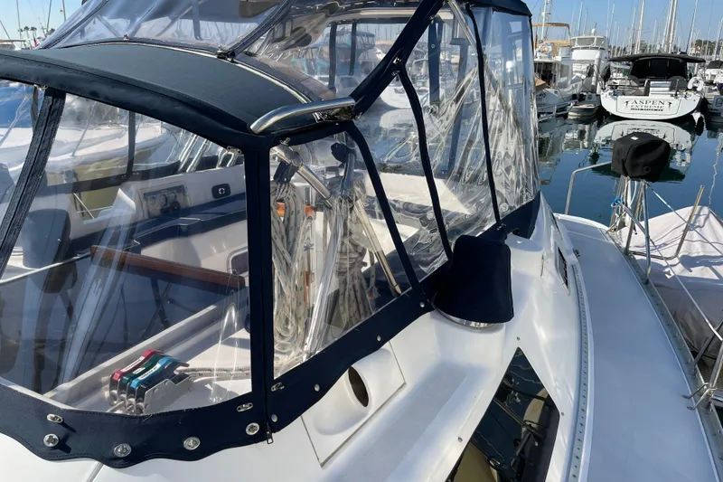 Slide: The Image of 1998 Hunter Passage 42 sailboat with clear cockpit enclosure in marina. - 17