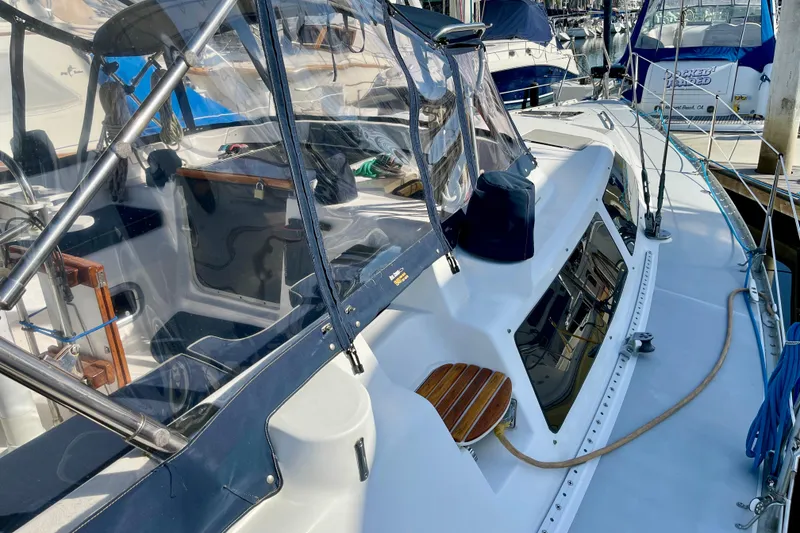 Slide: The Image of 1998 Hunter Passage 42 sailboat with covered cockpit and sleek deck design. - 19