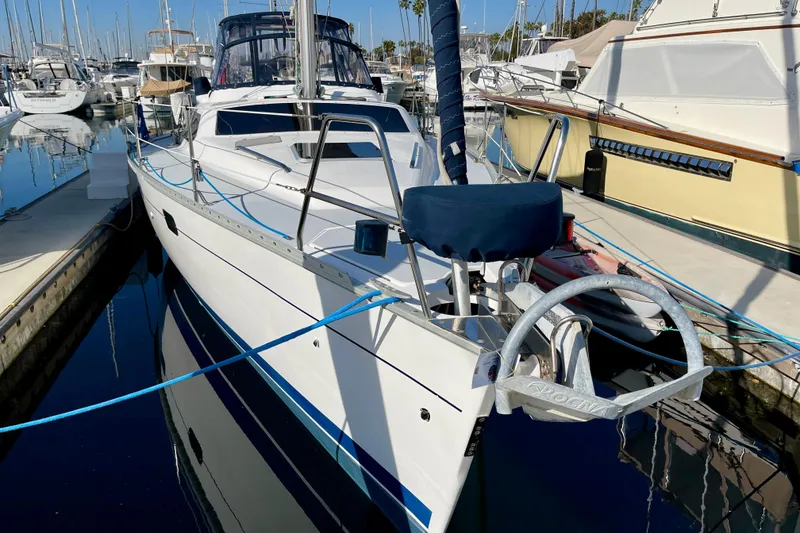 Slide: The Image of 1998 Hunter Passage 42 sailboat docked in marina, surrounded by other boats. - 3