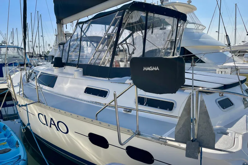 Slide: The Image of 1998 Hunter Passage 42 sailboat docked, featuring "CIAO" on the side and a Magma grill. - 4