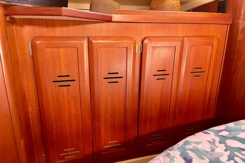 Slide: The Image of Wooden cabinet doors inside a 1998 Hunter Passage 42 yacht interior. - 48