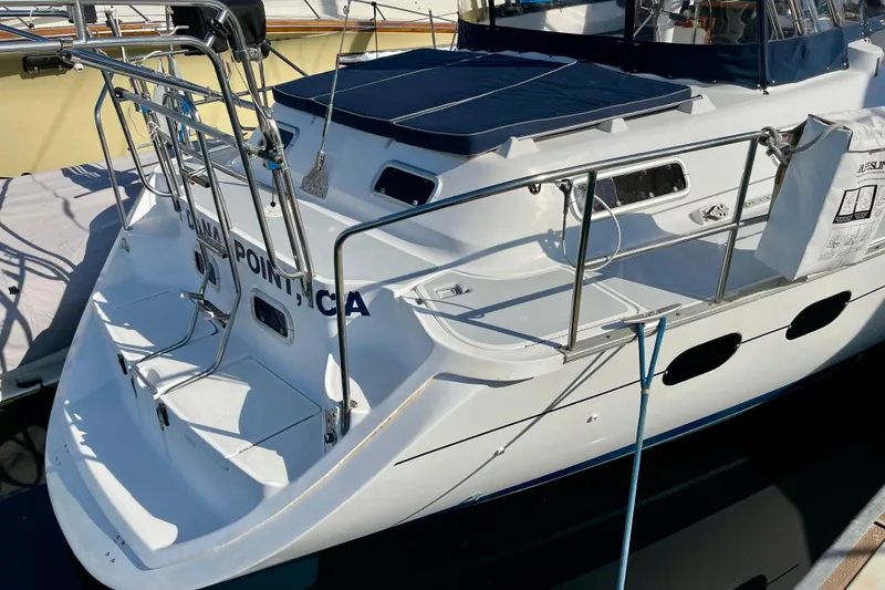 Slide: The Image of 1998 Hunter Passage 42 sailboat docked, featuring a spacious deck and sleek design. - 6