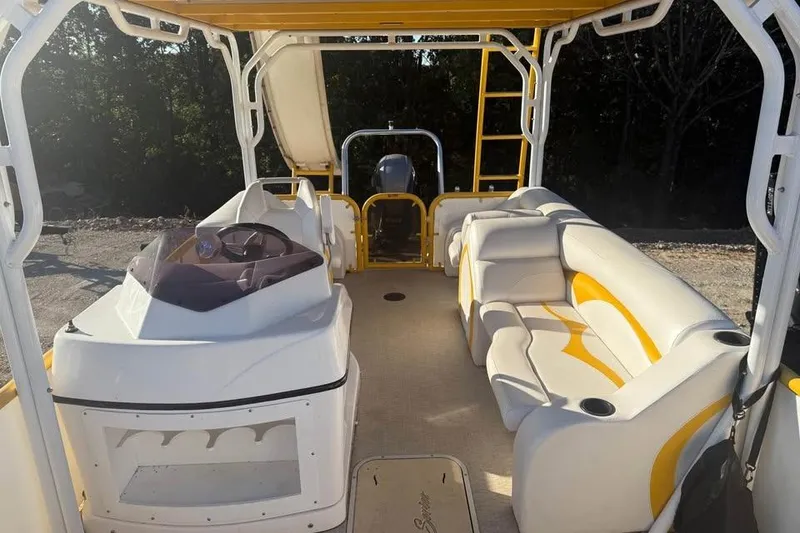 Slide: The Image of 2022 Aloha Pontoon Tropical 260 interior with seating and steering console. - 11