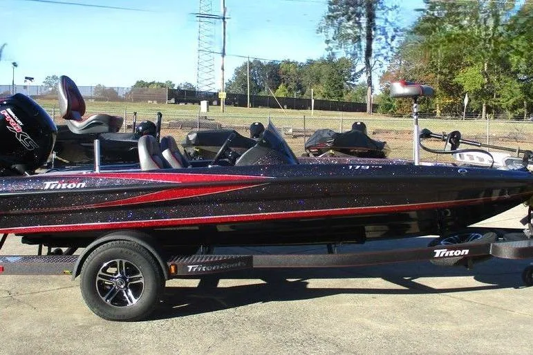 Slide: The Image of 2026 Triton 179 TrX boat dashboard with steering wheel and gauges. - 2