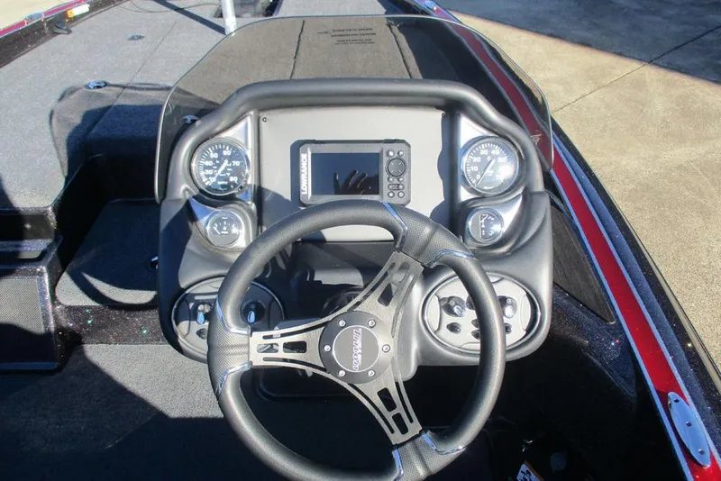 Slide: The Image of 2026 Triton 179 TrX bass boat on trailer in outdoor setting. - 3