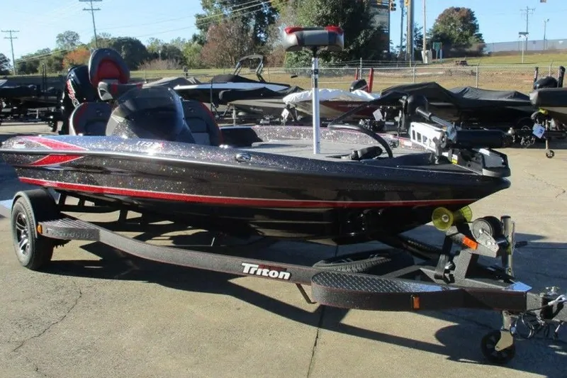 Slide: The Image of 2026 Triton 179 TrX boat with powerful outboard motor, parked on a trailer. - 4