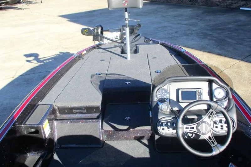 Slide: The Image of 2026 Triton 179 TrX boat on trailer outside Anglers Choice store. - 7