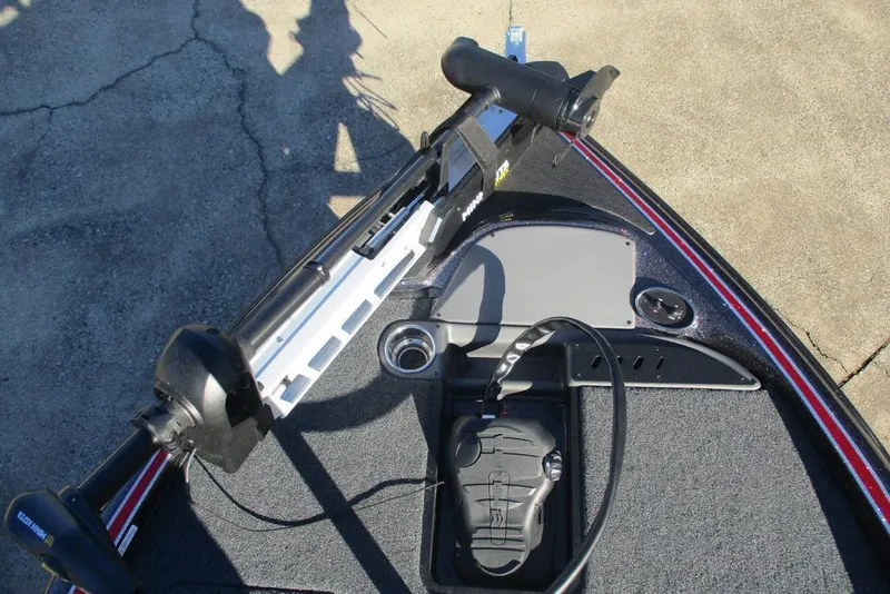 Slide: The Image of 2026 Triton 179 TrX boat deck with seat and trolling motor, in a sunny outdoor setting. - 9