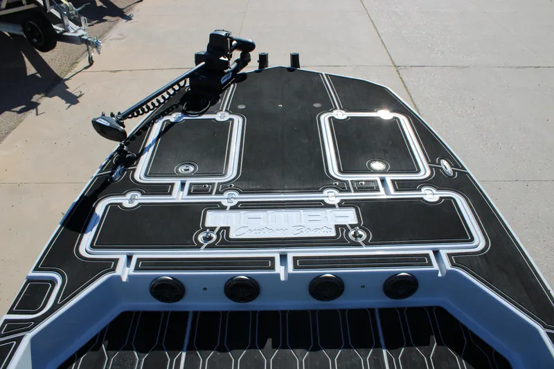 Slide: The Image of 2025 Mamba 24 Cat Elite boat deck with sleek black and white design. - 13