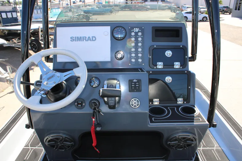 Slide: The Image of Dashboard of 2025 Mamba 24 Cat Elite boat with steering wheel and Simrad display. - 17
