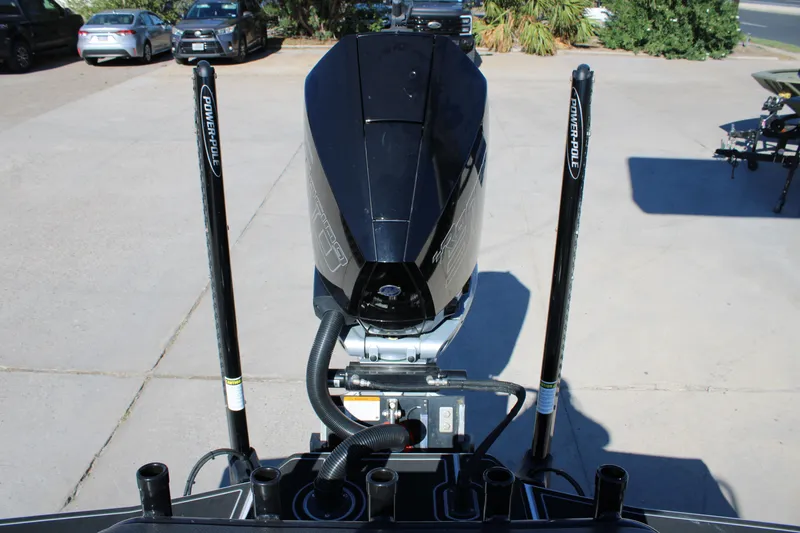 Slide: The Image of 2025 Mamba 24 Cat Elite boat engine with Power-Pole anchors in a parking area. - 19