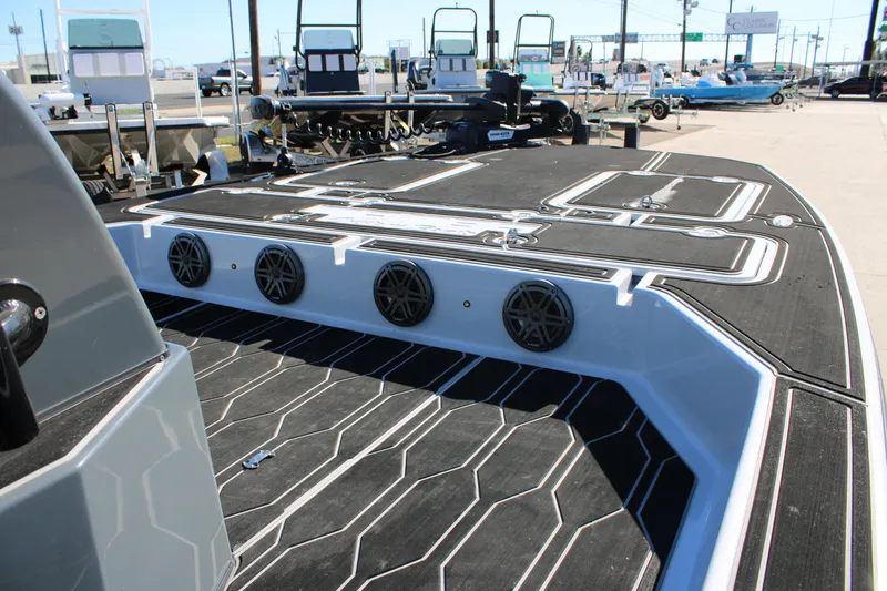 Slide: The Image of 2025 Mamba 24 Cat Elite boat interior with sleek black deck and speaker system. - 20