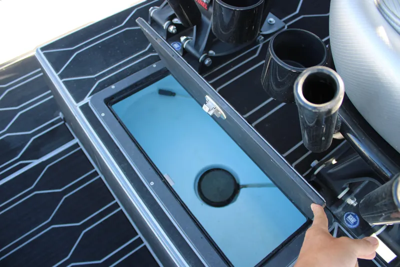 Slide: The Image of Livewell compartment on 2025 Mamba 24 Cat Elite boat with rod holders and sleek flooring. - 22