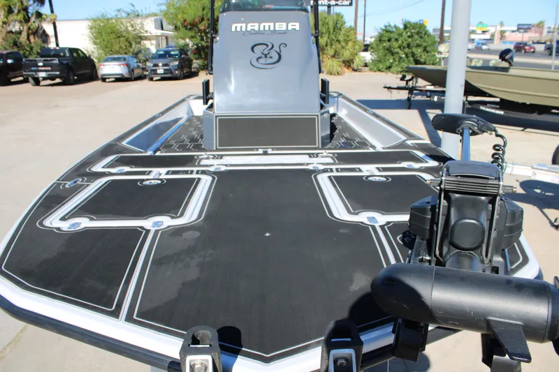 Slide: The Image of 2025 Mamba 24 Cat Elite boat with sleek black deck design. - 9