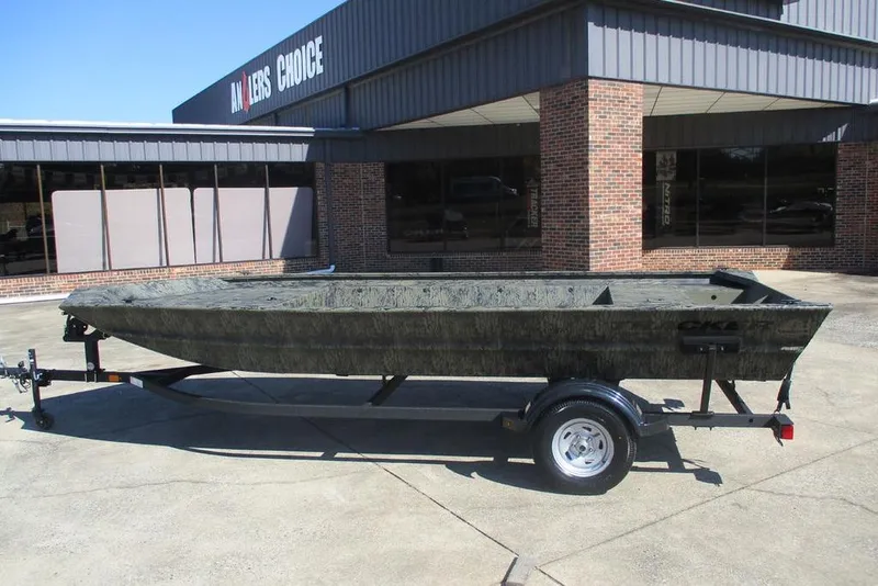 Slide: The Image of 2026 Tracker Grizzly 1860 Utility boat on trailer outside dealership. - 5