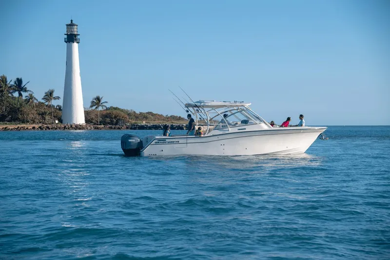 Slide: The Image of Grady-White Freedom 325 boat with twin outboard engines, year 2026. - 18