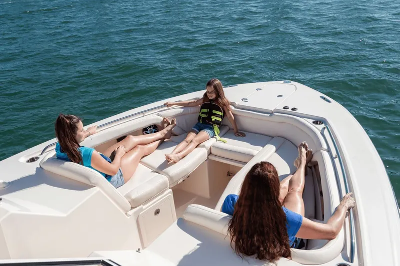 Slide: The Image of Grady-White Freedom 325 boat, 2026 model, on calm water. - 2