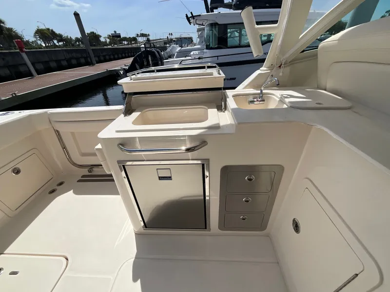 Slide: The Image of Grady-White Freedom 325 boat kitchen with sink and storage, year 2026. - 23