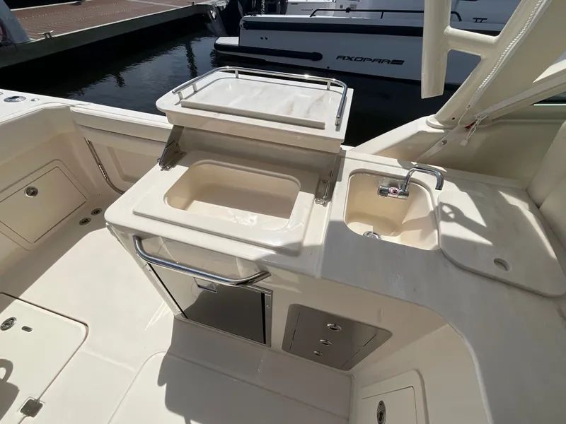 Slide: The Image of Grady-White Freedom 325 boat kitchen with sink and storage, year 2026. - 25
