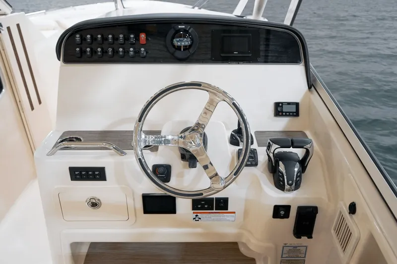 Slide: The Image of 2026 Grady-White Freedom 325 boat on calm water. - 4