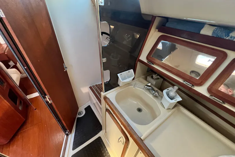 Slide: The Image of Interior of 1990 Hunter Legend 35.5 sailboat bathroom with sink and wooden accents. - 21