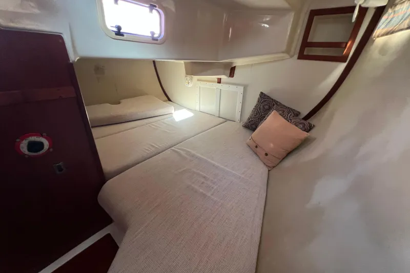Slide: The Image of Cozy cabin interior of 1990 Hunter Legend 35.5 sailboat with bedding and pillows. - 22