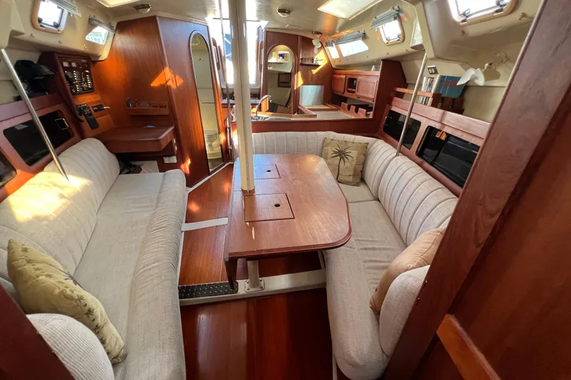 Slide: The Image of Interior of 1990 Hunter Legend 35.5 sailboat with cozy seating and wooden finishes. - 25