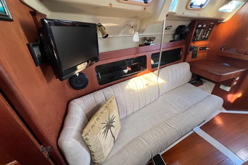 Slide: The Image of Interior of 1990 Hunter Legend 35.5 yacht with sofa, TV, and navigation station. - 26