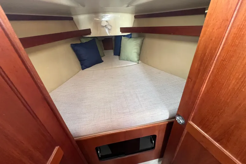 Slide: The Image of Cozy cabin interior of 1990 Hunter Legend 35.5 sailboat with cushions and wooden finish. - 27